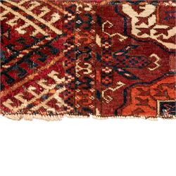 Persian Bokhara crimson ground rug, the field decorated with five rows of repeating Gul motifs with interspersed geometric design, enclosed by a guard band of further geometric-style Gul designs comprised of hook motifs