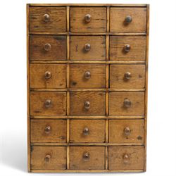 Nest of eighteen Victorian oak and pine spice drawers with turned pull handles 64cm x 46cm