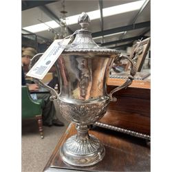 George III silver two handled campana shape cup and cover with pineapple lift, the body with cartouche surrounded by flowers above leaves and scrolls on a pedestal foot with acanthus leaf decoration H29cm London 1764, makers marks rubbed