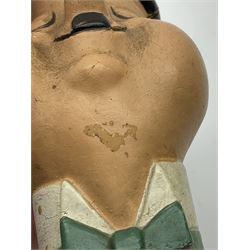 Mid-20th century composition bust of Oliver Hardy depicted smiling with eyes closed and wearing a top hat H11.5cm