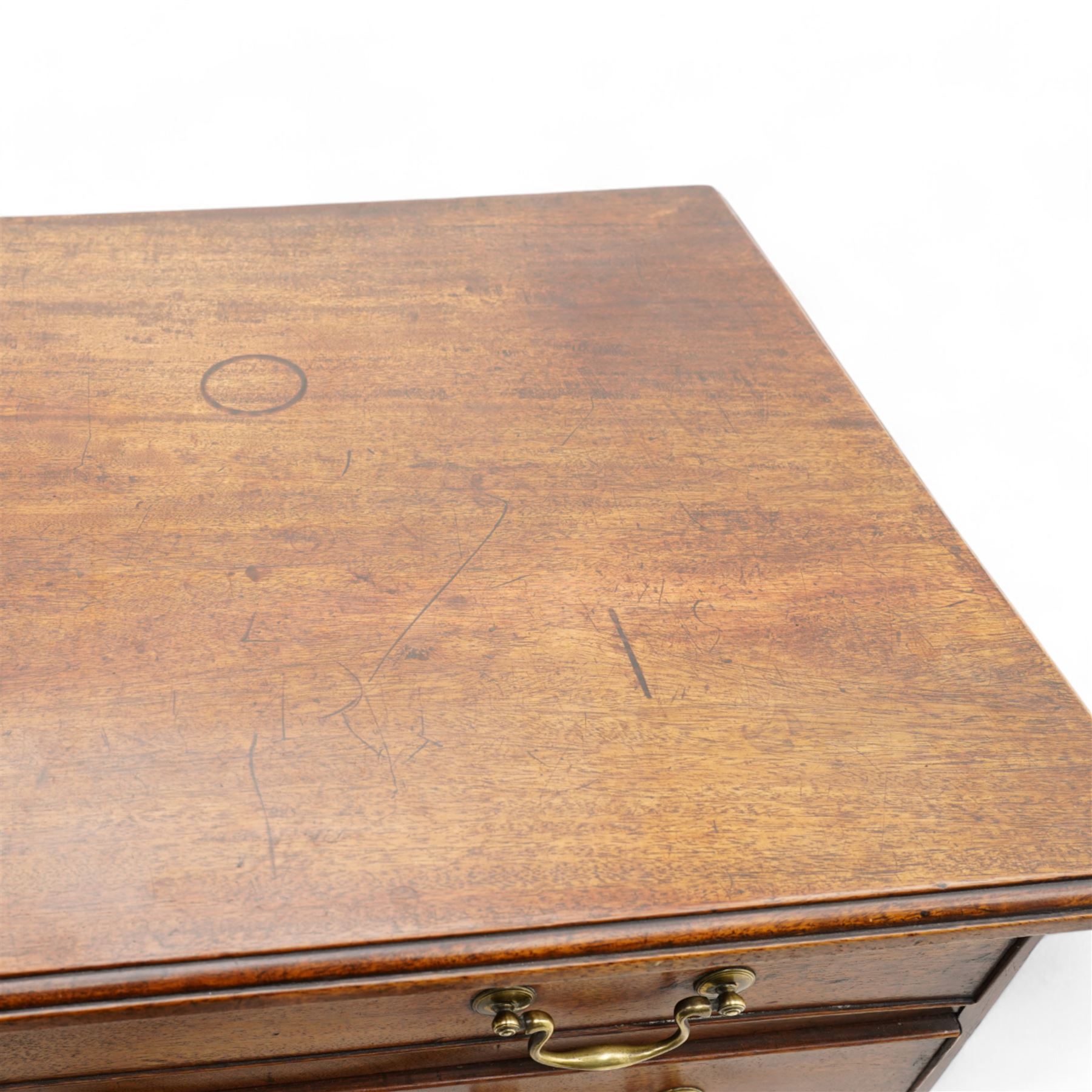 George III mahogany chest, moulded rectangular top over five long cock-beaded drawers, each fitted with brass swan neck handles and circular plates, with shaped brass escutcheons, lower moulding over ogee bracket feet 