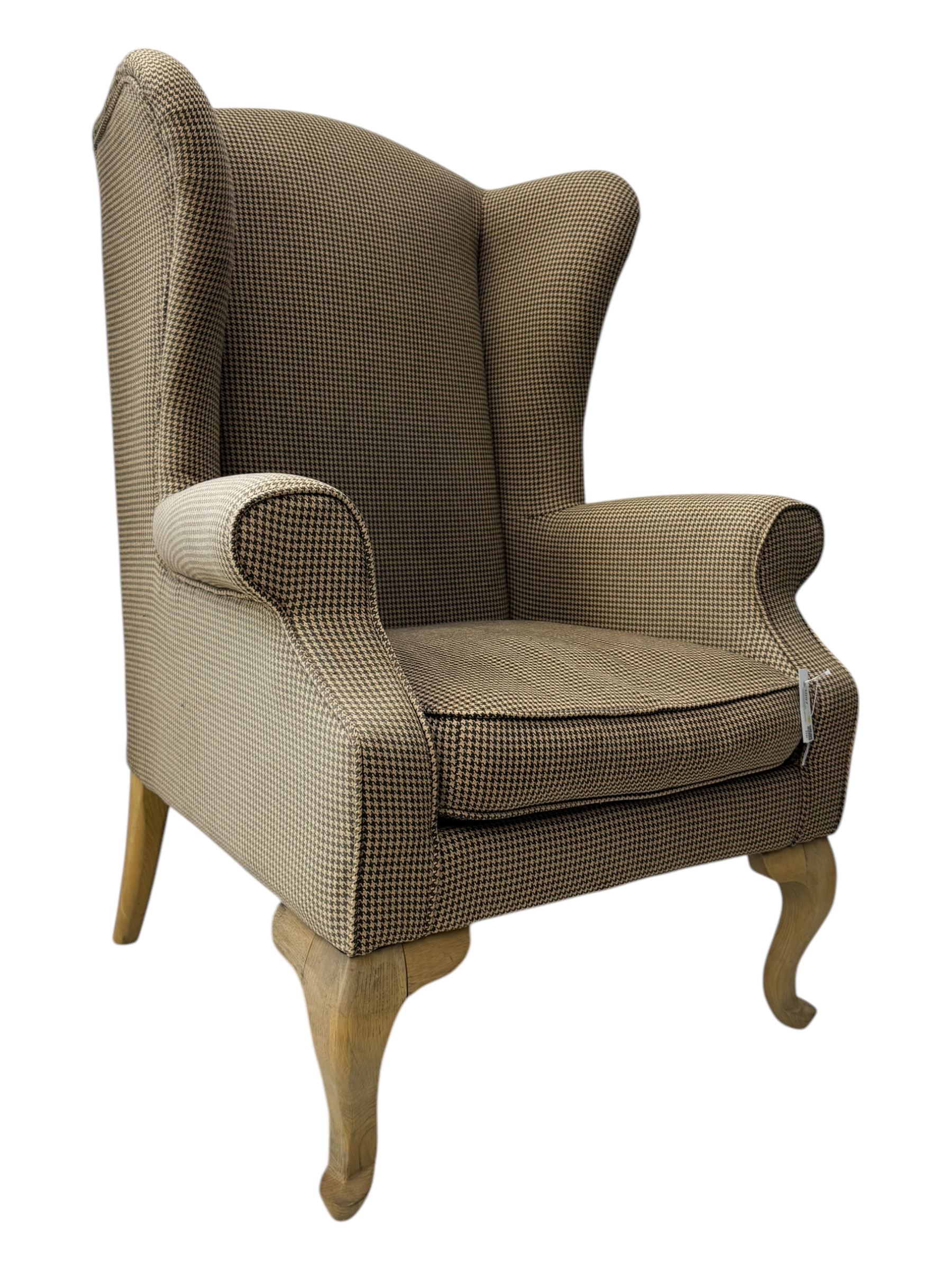 Hardwood-framed wingback armchair, upholstered in dog tooth pattern fabric, on cabriole supports 