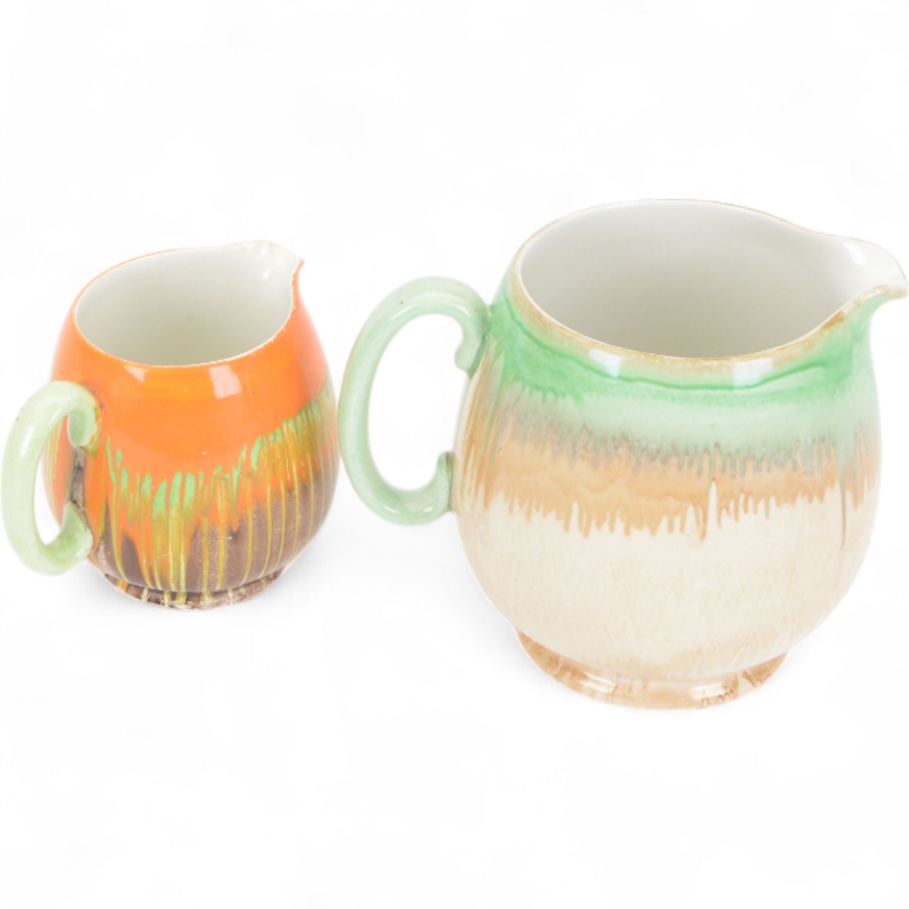 Four pieces of Shelley Harmony dripware, comparing ginger jar and three jugs, largest jug H23cm