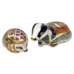 Two Royal Crown Derby paperweights, Moonlight Badger, with gold stopper and Orchard Hedgehog, with gold stopper, both with printed mark beneath   