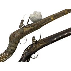 Two North African flintlock guns for restoration or wall display comprising blunderbuss with Moorish style full inlaid hardwood stock L102cm; and musket, the Moorish style full inlaid hardwood stock with five brass barrel bands L113cm (2)