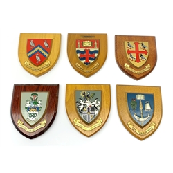 Three shield shaped university wall plaques, comprising St Edmund Hall, Oxford, University of Machester, and University of Loughborough, together with three further examples with Latin phrases, comprising Via Veritas Vita, Vires Acquirit Eundo, and Sapientia Urbs Conditur, also marked Nottingham University. (6). 