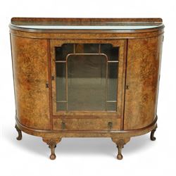 Early 20th century burr walnut display side cabinet, the glass inset top over a central glazed door with geometric astragal glazing, flanked by curved cupboards, shaped apron fitted with drawer, on cabriole legs with shell carved knees and pad feet