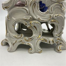 Figure group, probably Volkstedt, modelled as a courting couple seated before a table, the ornate bench and table conforming with and leading from the gilt heightened scrolling base, with blue painted mark beneath, H14.5cm
