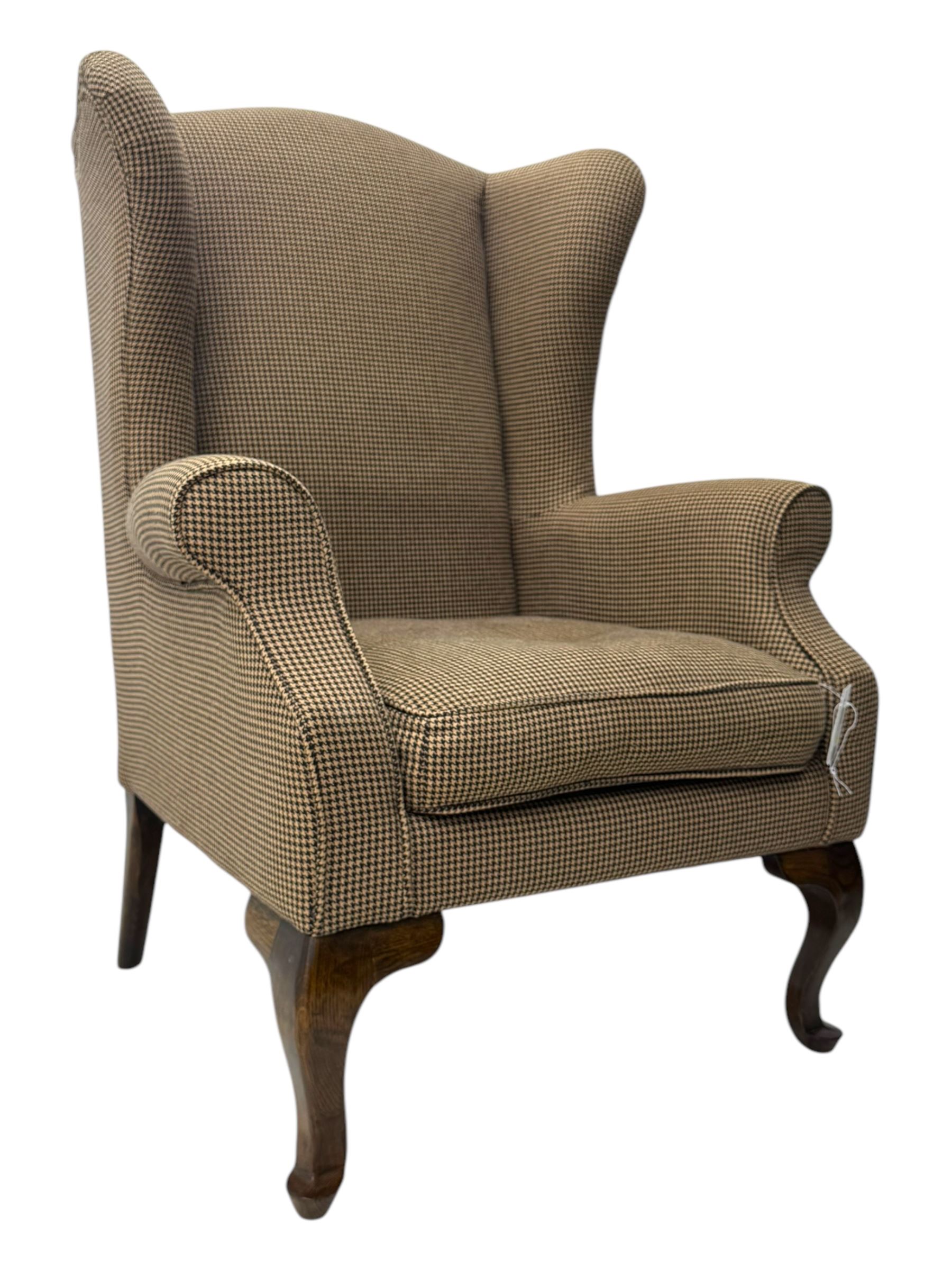 Hardwood-framed wingback armchair, upholstered in dog tooth pattern fabric, on cabriole supports 