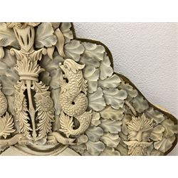 Pair 19th century French Dieppe bone and ivory wall mirrors, the oval bevelled mirror plates within rectangular frames with shaped tops, profusely decorated with ivory leaves, further detailed with carved bone armorial type crest inscribed 'SGOTORVM', putti, fish and mask heads, H81cm W48cm