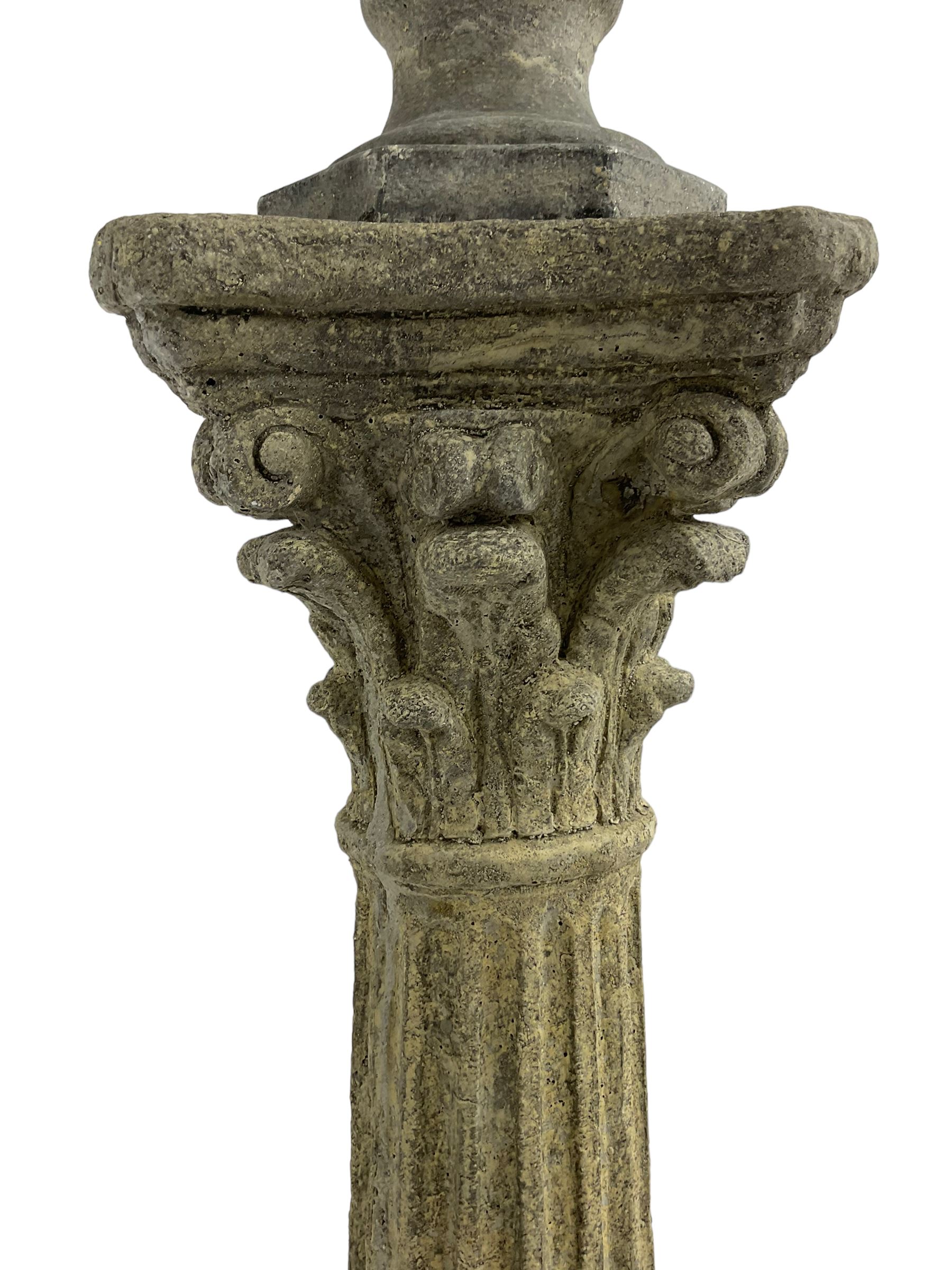 Classical design cast stone female bust depicting Artemis, raised on fluted Corinthian column with acanthus leaf capital, stepped square base, looking right 