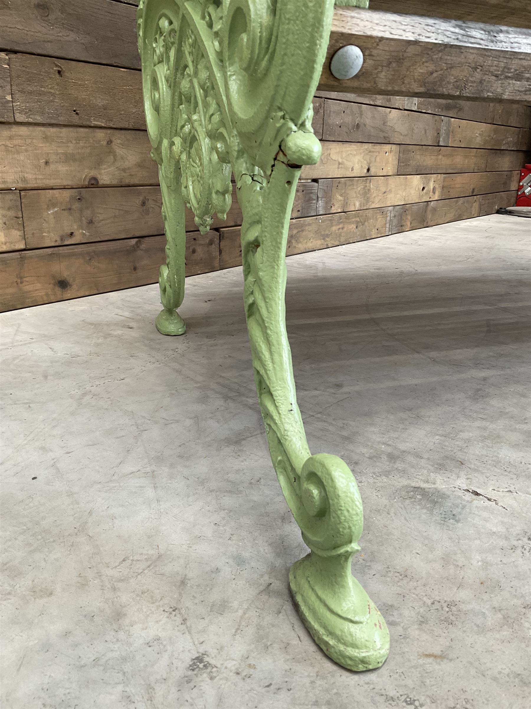 Early 20th century ornate green painted cast iron and hardwood slatted garden bench