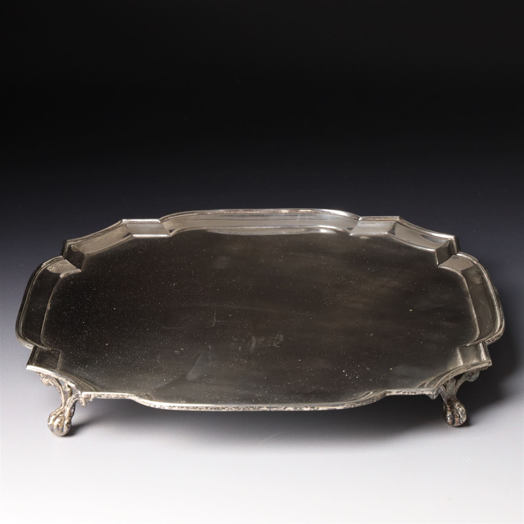 Square silver salver with canted corners and raised border on claw and ball feet 25cm London 1934 Maker Searle & Co Ltd