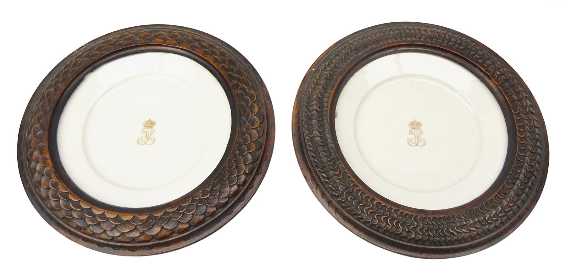 Pair mid 19th century Sevres porcelain plates, with gilt Louis Phillippe crowned monogram to centre upon a white glazed ground, with blue crowned LP mark, iron red destination mark for Chateau D'Eu, and chrome green cancelled potting mark S67 beneath, in carved oak mounts, overall D34cm
     