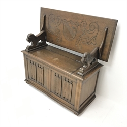 Early 20th century oak monks bench, tilt top, carved lion arms, hinged seat, plinth base, W107cm, H76cm, D45cm