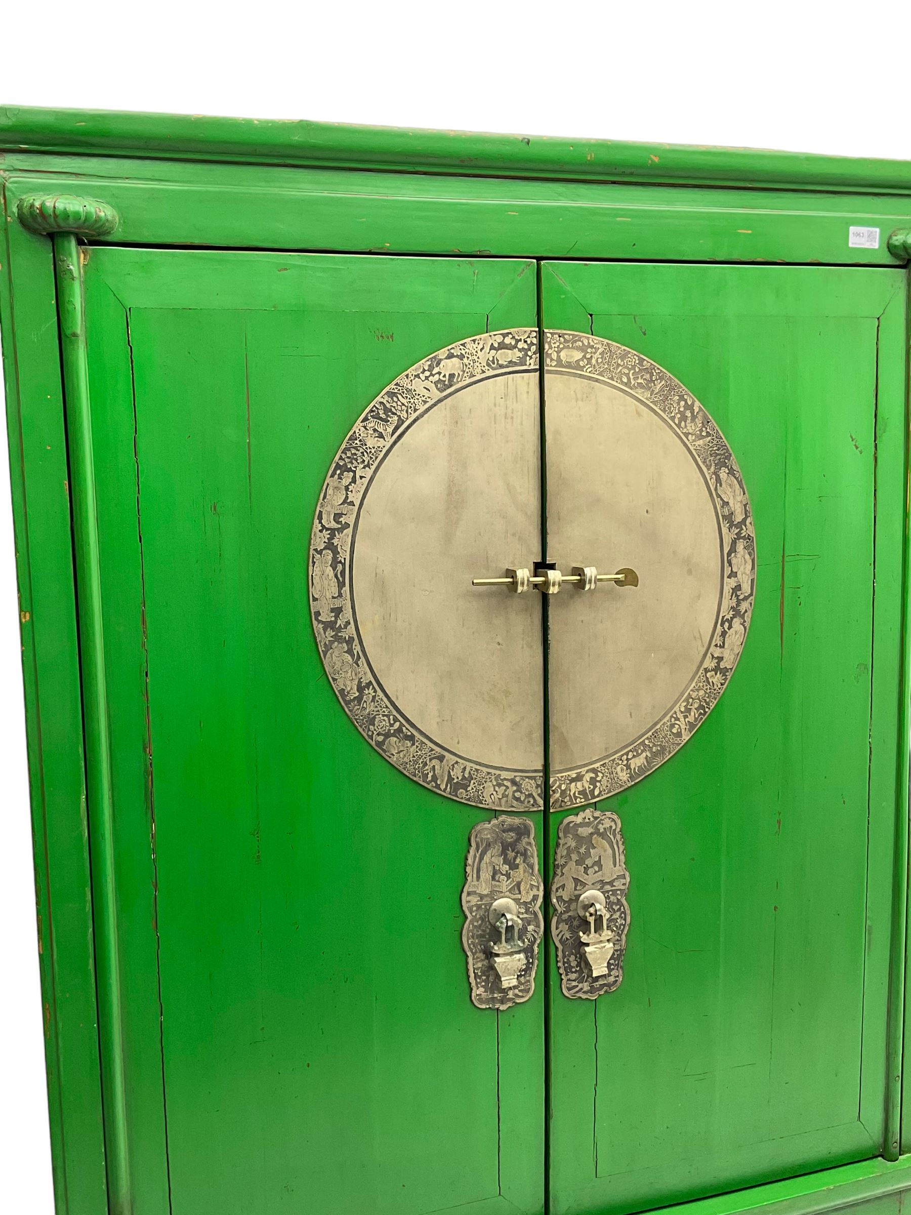 Chinese green lacquered hardwood moon cabinet, two panelled doors with metal mounts decorated with the zodiac animals and traditionally dressed figures, enclosing two drawers and shelves over single secret compartment