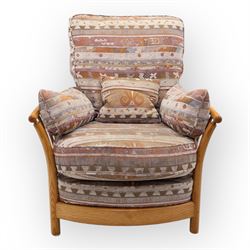 Ercol - Renaissance ash and elm high back armchair, upholstered in geometric Kilim patterned fabric with padded back, seat and arm cushions, curved stick back frame and turned supports