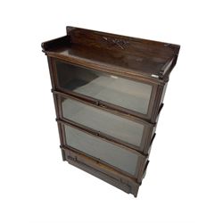 Globe Wernicke - early 20th century oak library bookcase, three tiers enclosed by hinged and sliding glazed doors, drawer to base