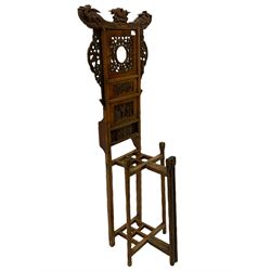 Chinese hardwood hall stand, the raised back surmounted by ho-ho birds and carved with pierced floral fretwork and relief carved panels, four division umbrella stand, turned front supports
