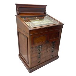 Edwardian mahogany artist's cabinet once belonging to the British artist Eli Marsden Wilson (1877-1965), raised panelled back mounted by carved brackets, sloped and hinged glazed lid enclosing paint holders and compartments, up-and-over panelled door revealing three slides, fitted with two banks of five graduating drawers with recessed brass handles, on skirted base.

Together with a quantity of artists' equipment and tools including paints, paintbrushes, charcoal, chalks, etc. and various prints relating to the life of the artist, including Quaker anti-war posters, Victorian Stevengraphs, and various chromolithographs 

Provenance: Removed from the studio of Eli Marsden Wilson. The cabinet comes to us for sale through family descent. The vendor is descendant of Marsden. Many further etchings removed from the cabinet are being sold in the Spring Art Sale, Friday 15th March 2024, Lots 265-271.

Notes: born in Ossett, Eli Marsden Wilson was the only son of Alfred Wilson, a foreman beamer, and Emma Marsden, and had five sisters. After studying at Wakefield College of Art, he moved to the Royal College of Art in London, where he became a pupil of Sir Frank Short. He had his first exhibit at the Royal Academy in 1905, the same year he married fellow artist Hilda Mary Pemberton.

A Quaker, vegetarian, and pacifist, he was a conscientious objector in World War I and as such was imprisoned in 1917 for two years. In September 1922 he was commissioned by Princess Marie Louise to produce miniature etchings for Queen Mary's Dolls' House at Windsor Castle; two such etchings are being sold in the Spring Art Sale, Friday 15th March 2024, Lot 265.