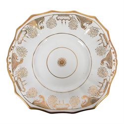 Late 19th century tea service, decorated in gilt with bands of seaweed type tendrils, thistles and cross hatch reserves upon a white glazed ground, comprising tea pot, twin handle lidded sucrier, milk jug, slop bowl, three serving plates, twelve cups and saucers and eleven side plates