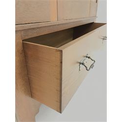 Arts and Crafts period oak wardrobe, projecting shaped cornice, single bevel edged mirrored door above drawer