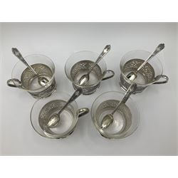 Early/mid 20th century Persian silver tea service, comprising circular serving tray, teapot, twin handled sucrier and cover, milk jug, five tea glasses with six silver holders, six tea spoons, and pair of sugar tongs, each profusely chased with foliate arabesque decoration, each bearing marks including 84 for 840 fineness, tray D40cm, teapot H16cm
