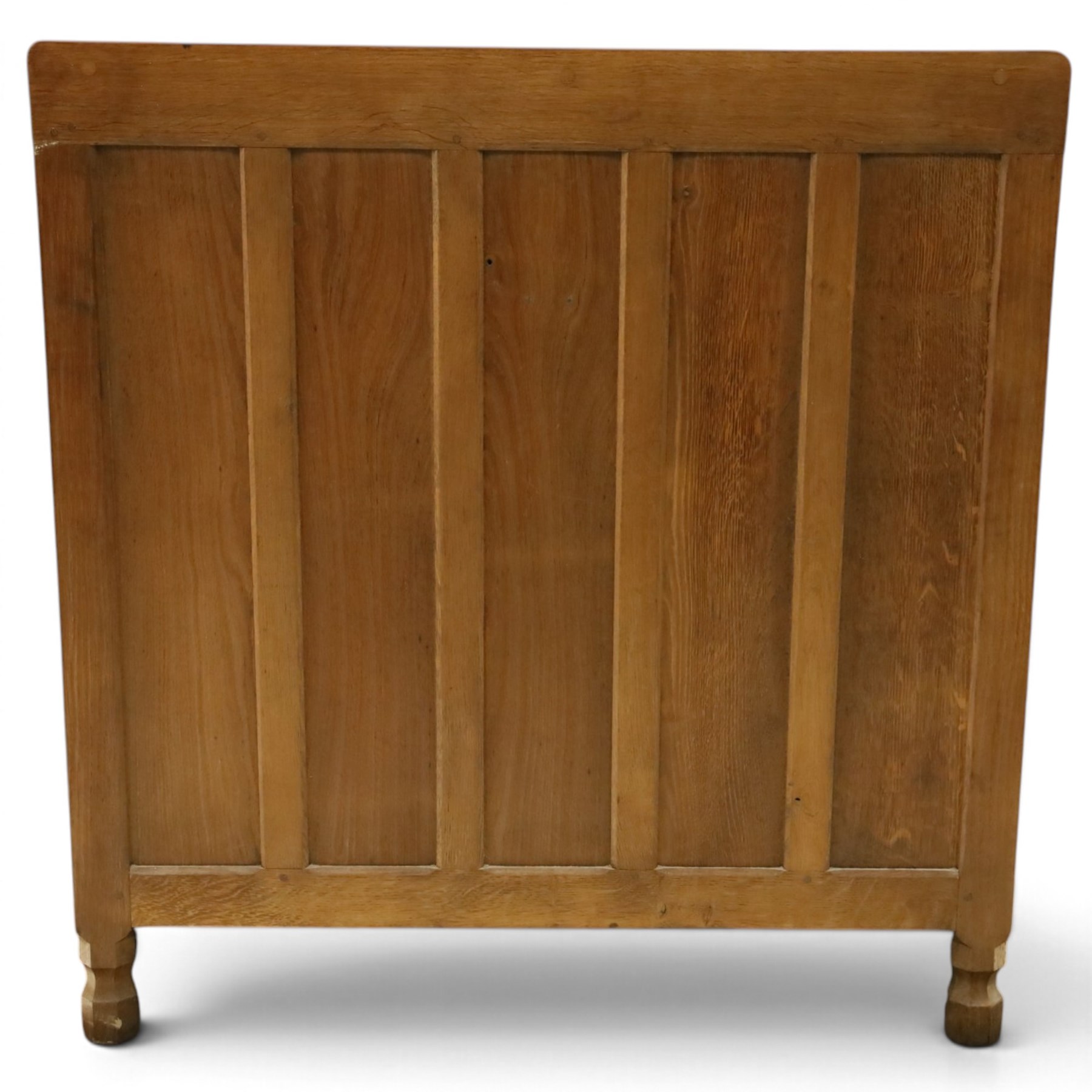 Mouseman - early-to-mid 20th century adzed and panelled oak chest, raised back over rectangular adzed top with canted corners, fitted with two short over three long drawers with turned knob handles, raised on octagonal feet, with carved mouse signature, by the workshop of Robert Thompson of Kilburn