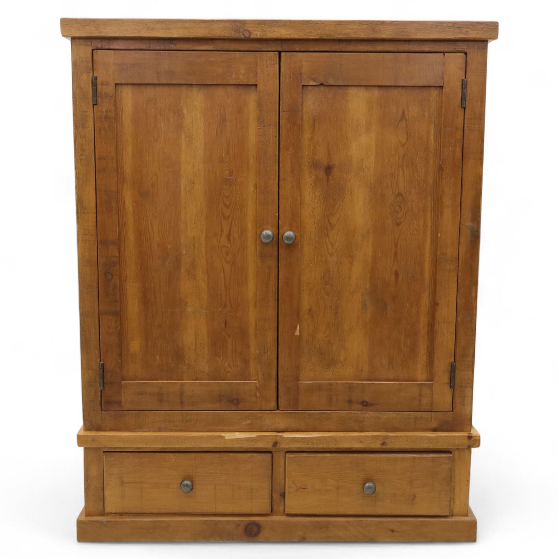 Contemporary pine hanging wardrobe, twin panelled doors enclosing open hanging space with brass rail, two drawers to lower section, on moulded plinth base
