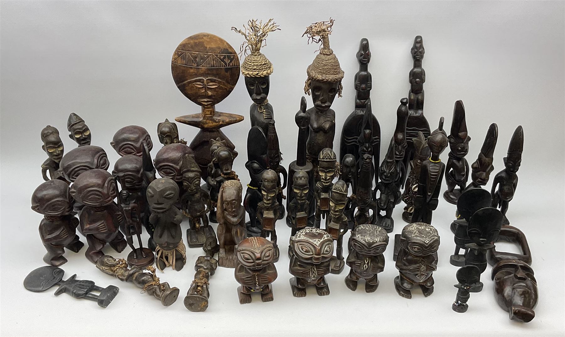 African carved wood figures, various forms and sizes including some with rope decoration, in two boxes