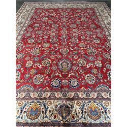 Large Fine Persian Kashan rug, red ground field decorated with large stylised flower heads, the ivory ground border with matching motifs and trailing foliage