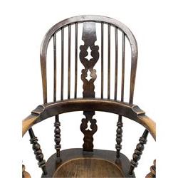 19th century oak 'Yorkshire/Lancashire' Windsor armchair, hoop spindle back with a pierced and fret work splat, curved arms on turned spindle supports, dished elm seat, turned supports with a double H stretcher base