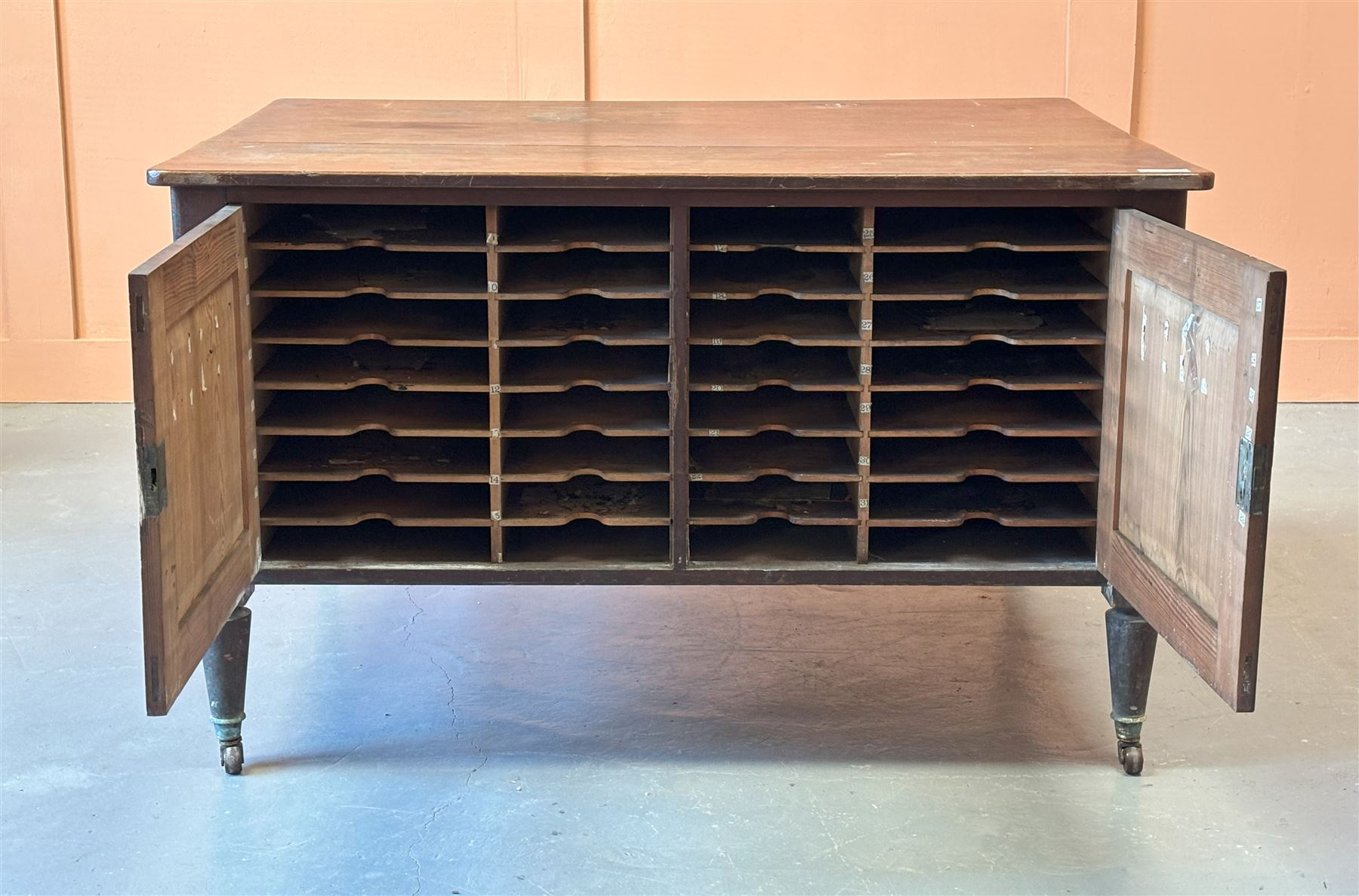 Late Victorian stained pitch pine free standing country house estate managers cabinet, the rectangular top above all round panelling enclosing an arrangement of cupboards, shelves and drawers, raised on turned and tapered supports terminating in brass and ceramic castors, ideal for kitchen island, H83cm, 137cm x 107cm. - COLLECTION BY APPOINTMENT FROM: The White House, Thirsk Road, Easingwold, York, YO61 3NF - CALL 01723 507111 TO ARRANGE