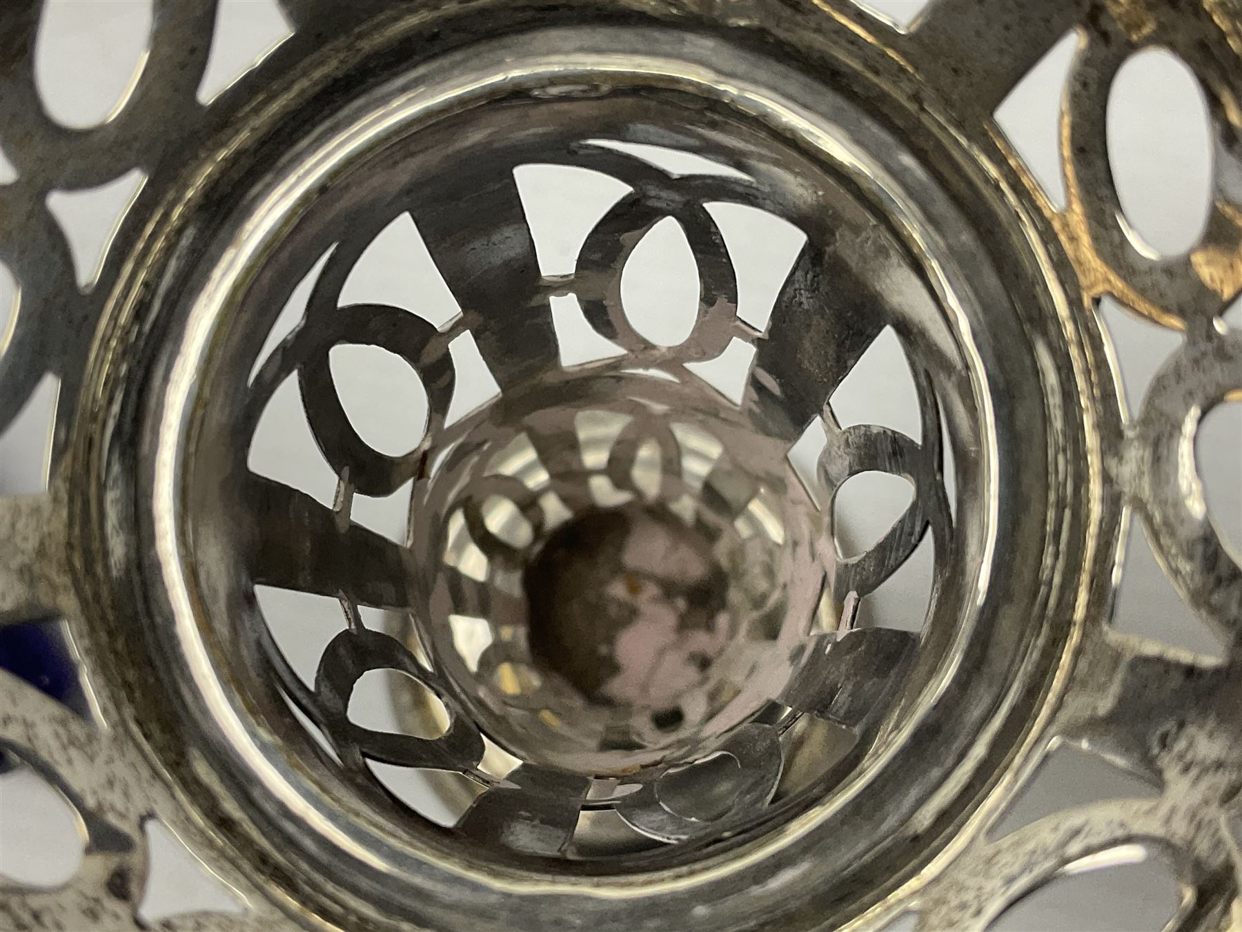 20th century silver specimen vase, of pierced trumpet form with flared rim, filled base, and blue glass liner, hallmarked Birmingham 