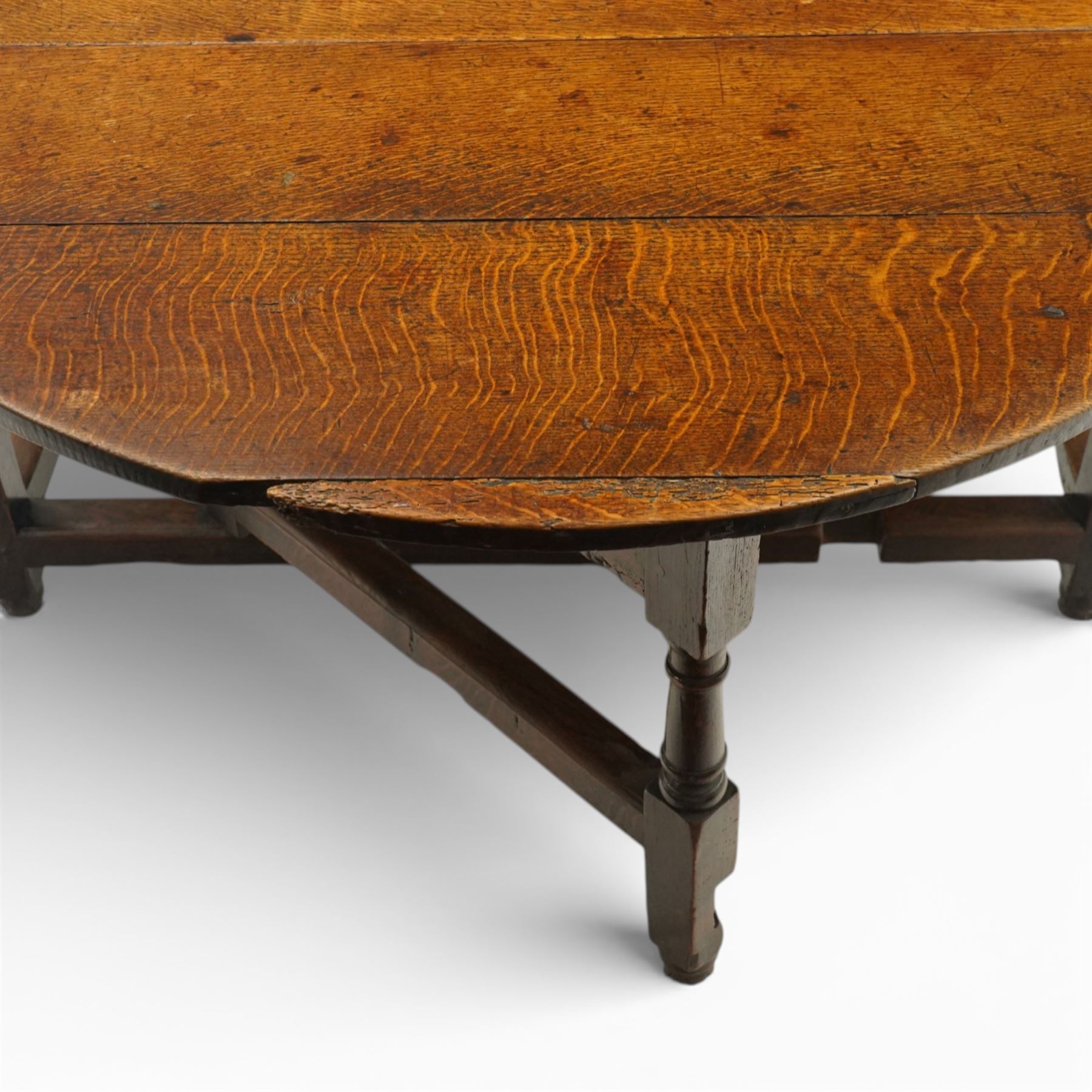 18th century large oak gateleg table, of plank top construction with visible dowels, with drop leaves to form an oval table 167cm in width, raised on block and turned supports