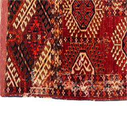 Vintage Bokhara hand-knotted rug, madder field woven in rows of octagonal Tekke guls arranged in vertical columns, each enclosing angular cruciform devices and tribal motifs, divided by narrow indigo lines, within multiple geometric borders incorporating stepped lozenges and latch hook devices, with cotton fringe ends 
