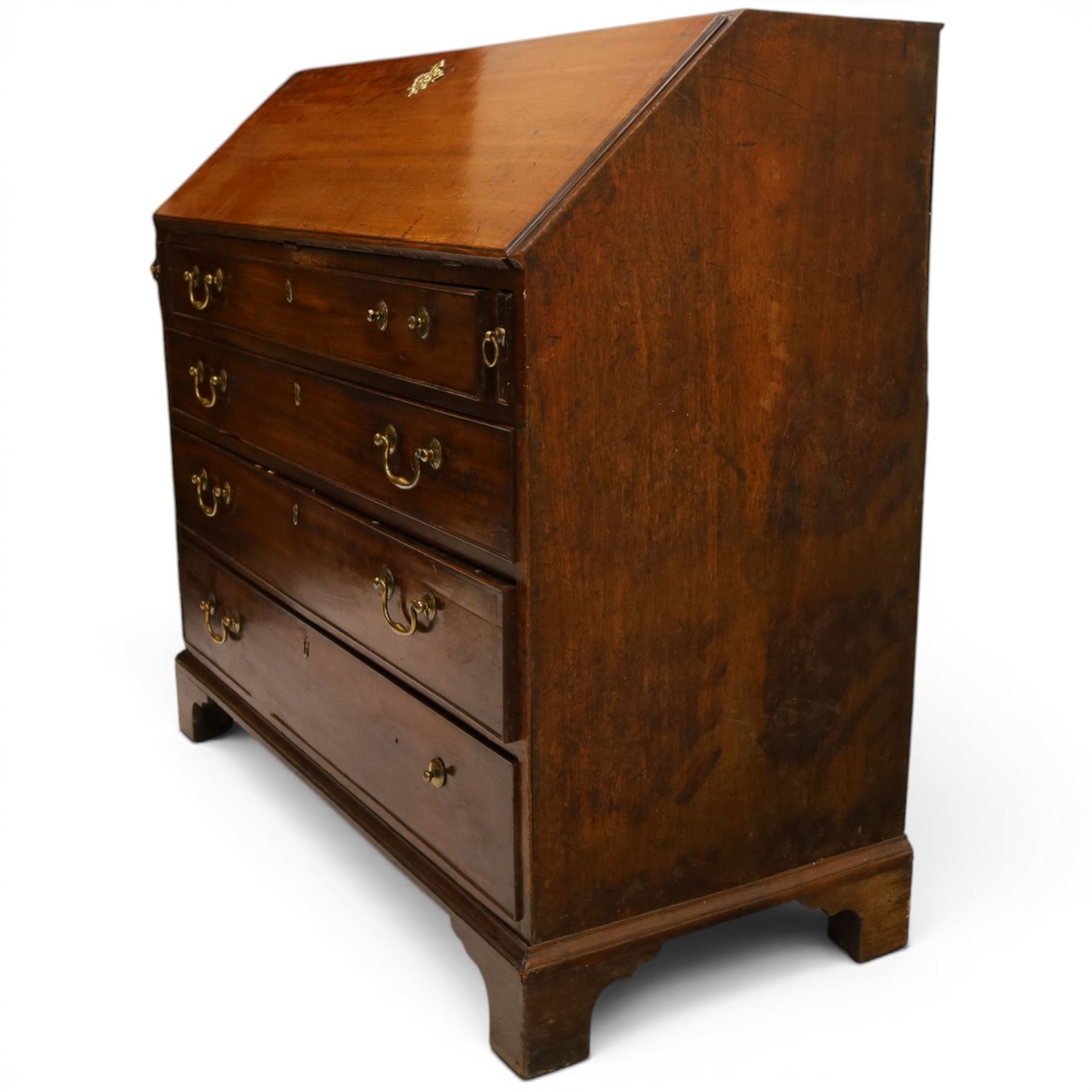 George III mahogany bureau of large proportions, the fall-front enclosing fitted interior with fluted column secret compartments and assorted pigeonholes and correspondence drawers flanking central cupboard, over four graduating cock-beaded drawers with original brass swan-neck handles, raised on bracket feet