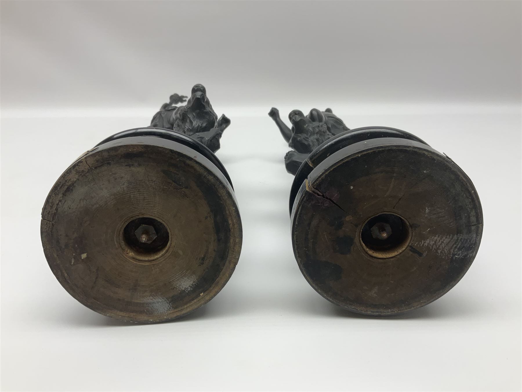 Pair of spelter figures, Le Force and Le Pouvoir, modeled as figures standing on lions, arms held aloft, H51cm 