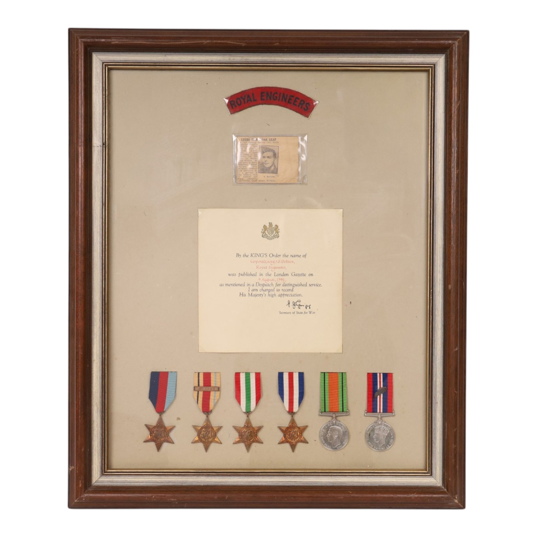 WWII British medal group, composing 1939-1945 Star, African Star, Italian Star, French and German Star, Defence medal and War medal with oak leaf clasp, awarded to Corporal S Dobson Royal Engineers, framed, with Royal Engineers shoulder badge and a mentioned in dispatches certificate, H58cm,W49cm 