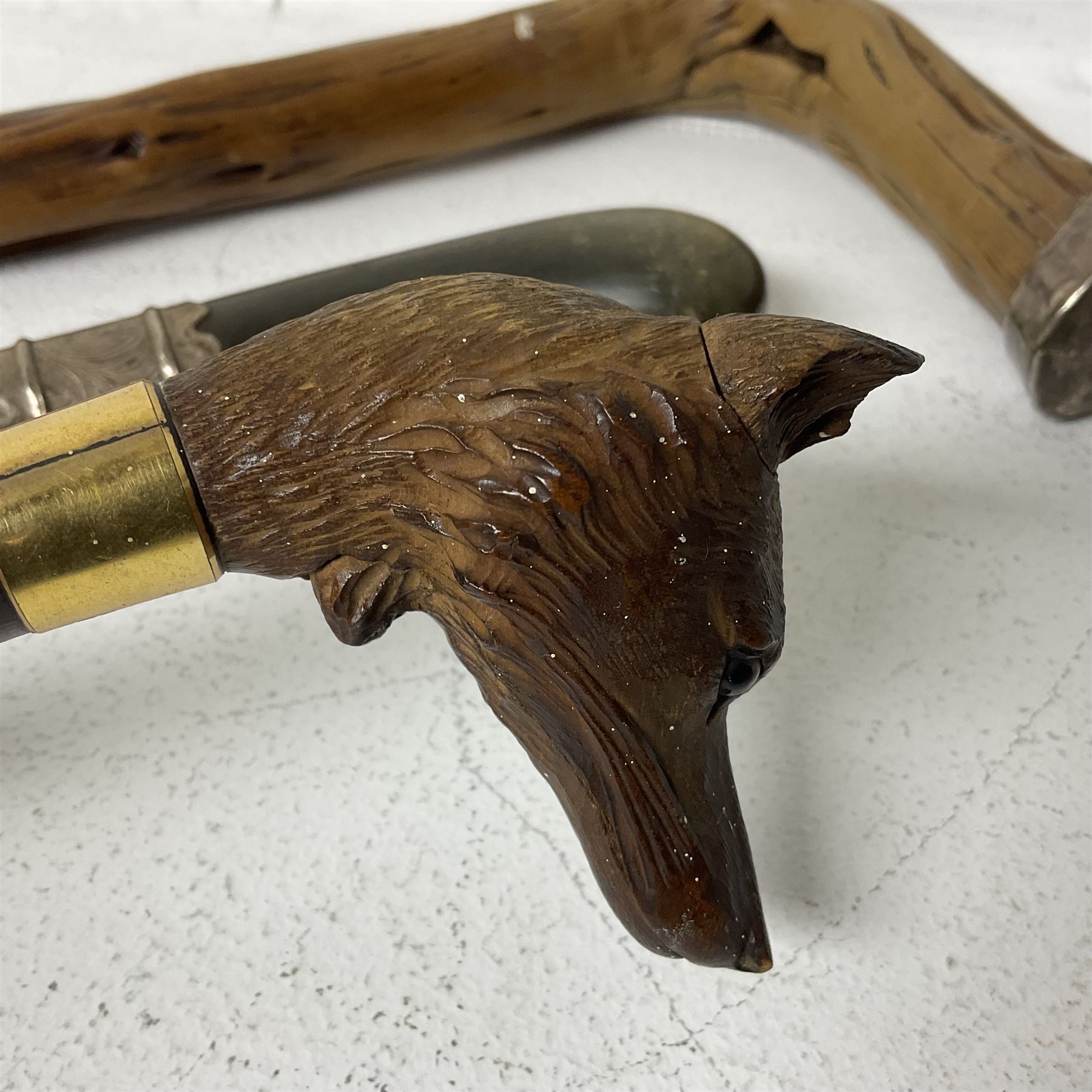 19th century painted bamboo walking cane, the handle carved as a fox with glass eyes, with gilt metal stamped LB, together with an ebonised wooden walking stick, with horn pommel and hallmarked silver collar and a curved wooden walking stick, with monogrammed white metal cap, tallest L90cm