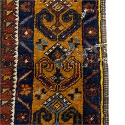 Turkish Anatolian wool rug, central stepped medallion on dark blue lozenge field, red spandrels with stylised hooked motifs, ochre border decorated with repeating geometric motifs and guard stripes