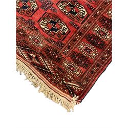 Bokhara red ground rug, decorated with two rows of Gul motifs, the border with geometric guard bands decorated with stylised plant motifs
