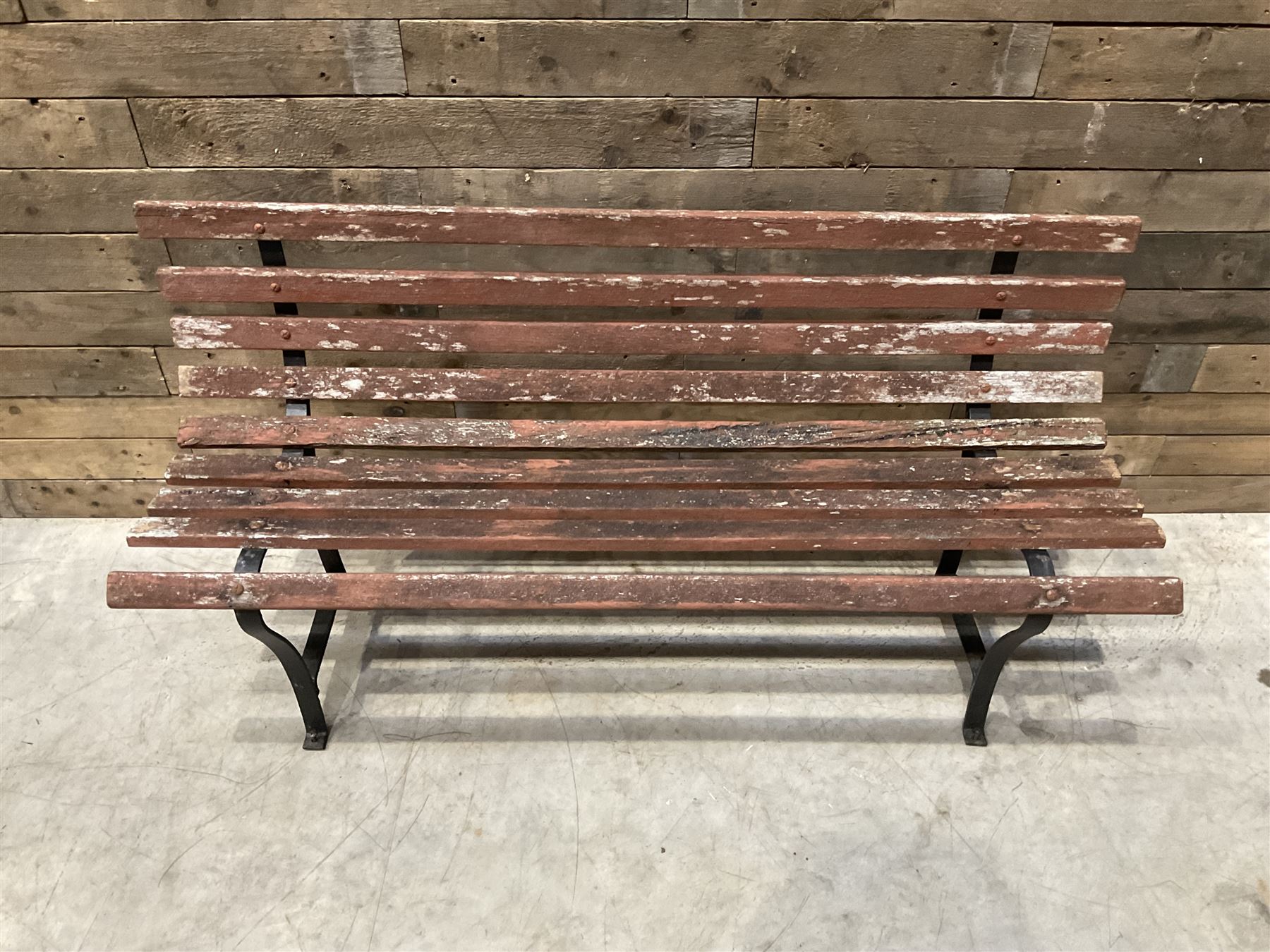 Wrought metal and wood slatted garden bench