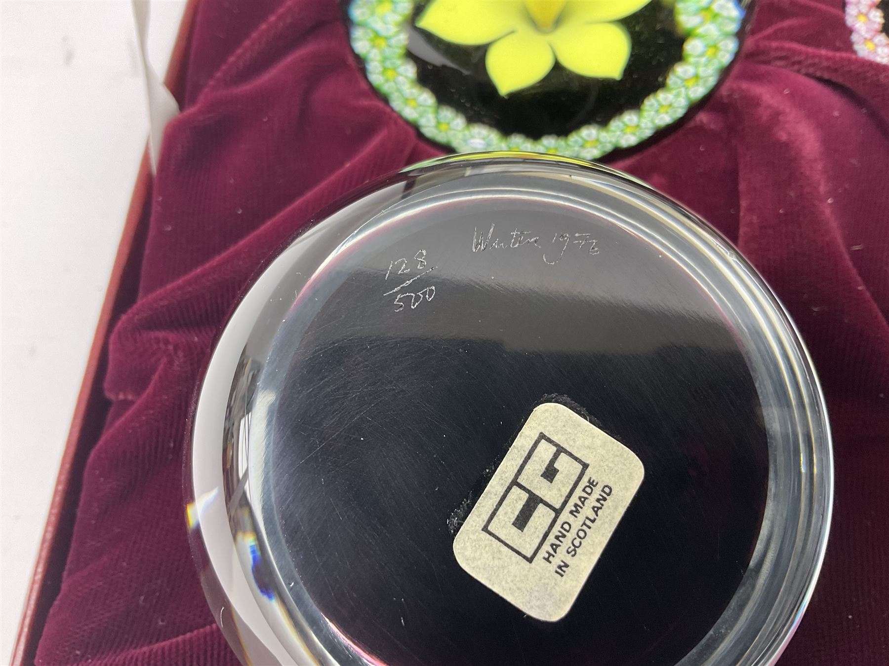 Set of four Caithness paperweights titled Four Seasons, in presentation box with certificate, designed by Colin Terris and made by William Mason, each internally decorated with a seasonal flower within a millefiori cane work garland, numbered 128 of 500