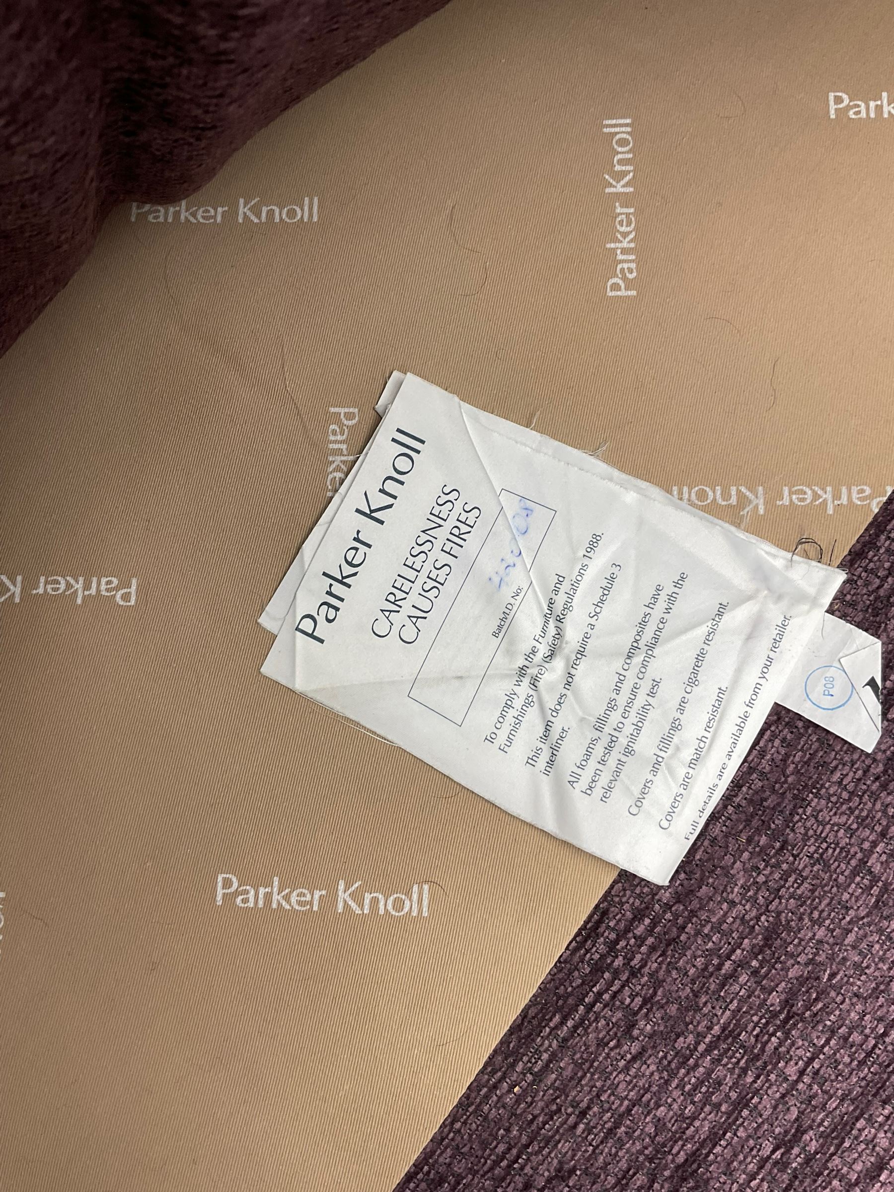 Parker Knoll - pair of large two-seat sofas upholstered in purple fabric, turned mahogany finish front feet with brass cups and castors 