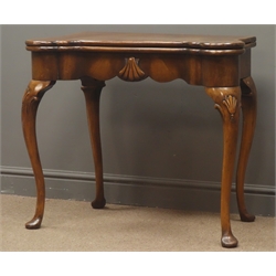  George I style walnut card table, double gate action, cross banded folded top with projecting corners, baise lined interior with candle and counter wells, shell carved shaped frieze and cabriole legs with pad feet,  W82cm, H70cm, (max)  