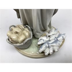 Lladro figure, The Loaves and Fishes, modelled as Jesus Christ with arms raised standing beside a basket of loaves and a basket of fish, sculpted by Salvador Furió, with original box, no 5896, year issued 1992, year retired 1997, H35cm