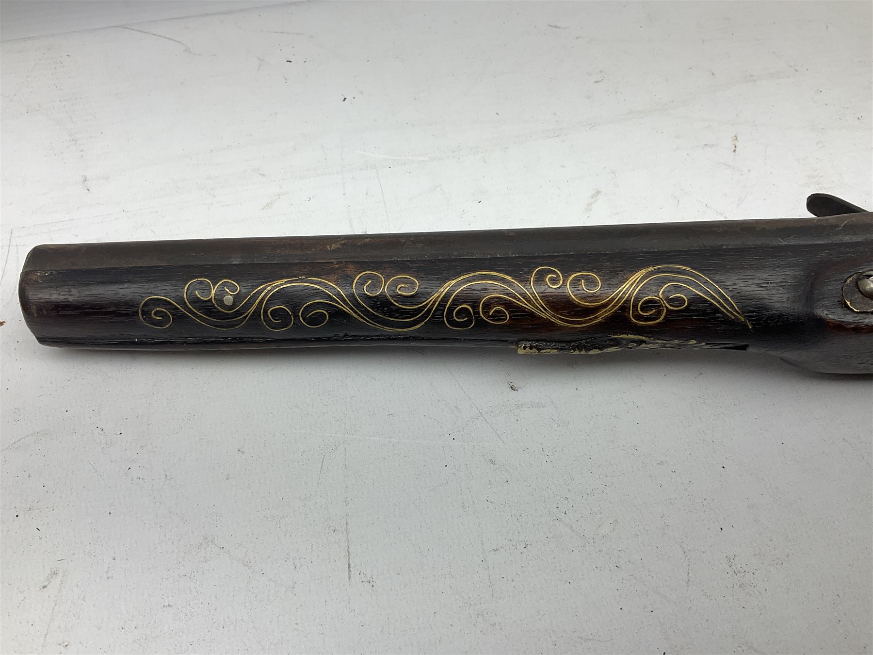 Reproduction flintlock pistol, the full walnut stock with brass filigree inlay and mounts and skull crusher butt L46cm; no visible proof marks FIREARMS CERTIFICATE REQUIRED OR RFD