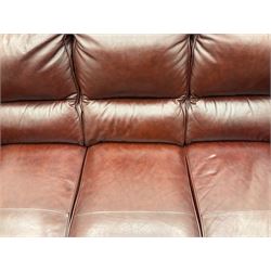 Three seat sofa and matching electric reclining armchair, upholstered in brown leather