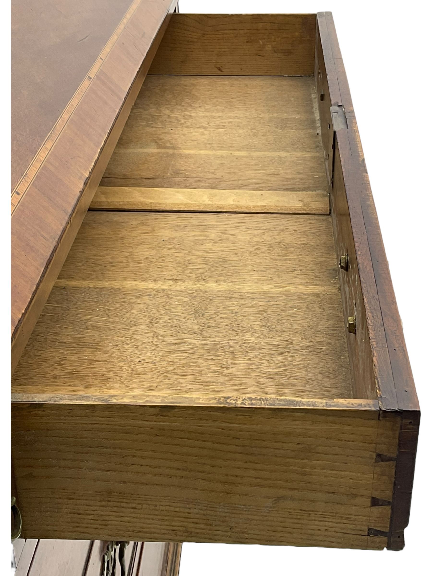 George III mahogany bureau, the conch inlaid fall front enclosing pigeon holes, shelves and central cupboard with inlaid flower motif, four graduating cock-beaded drawers below each with brass handles, lower moulded edge over shaped bracket feet